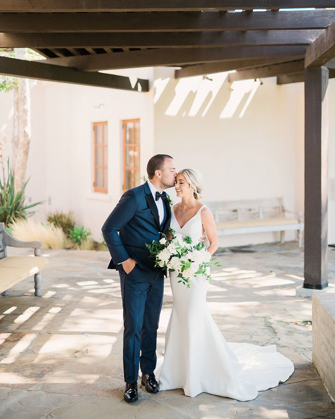 The Groom Kisses Bride's Forehead Tenderly