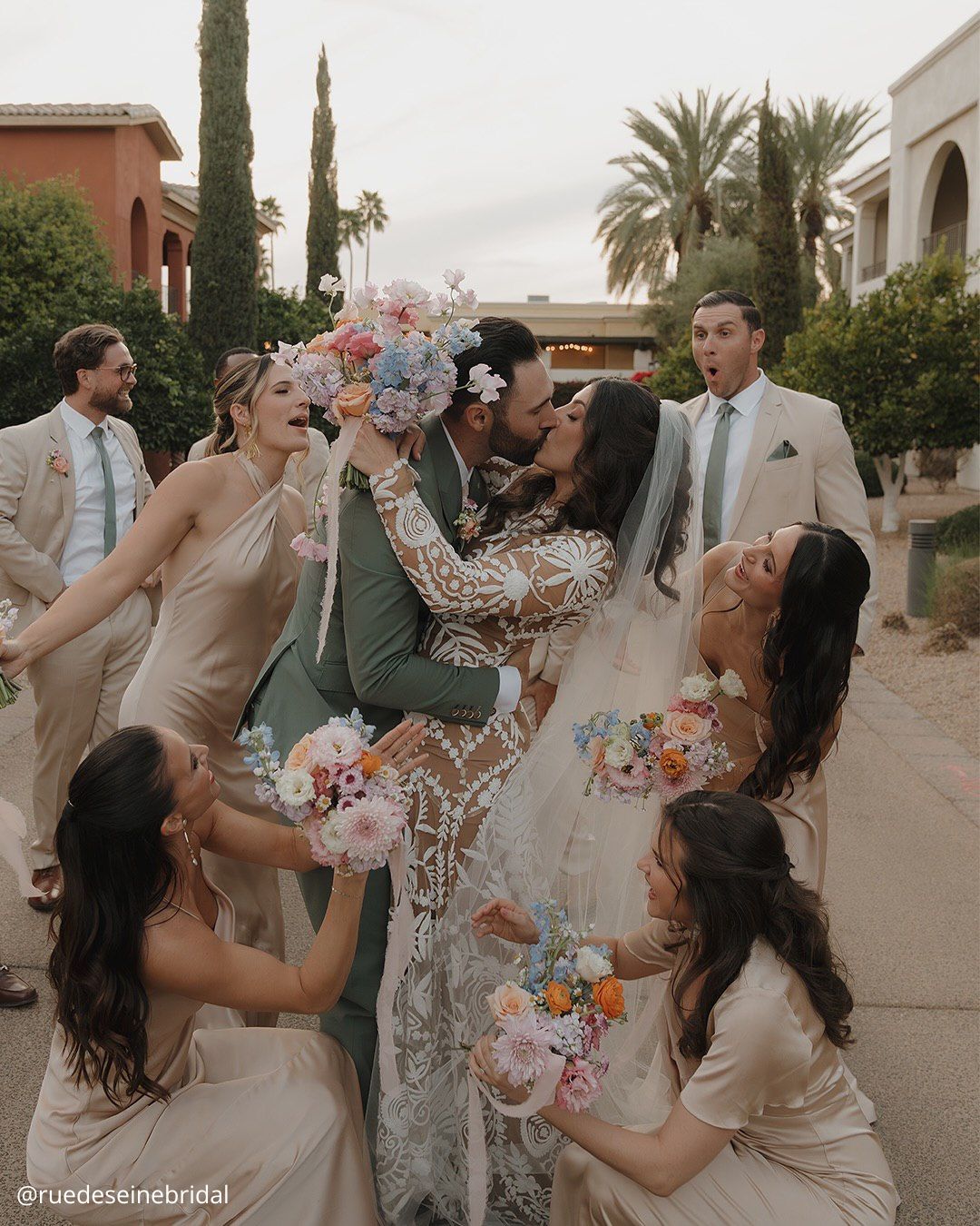 wedding photos brides kissing with fun friends all with a bouquet in hands ruedeseinebridal